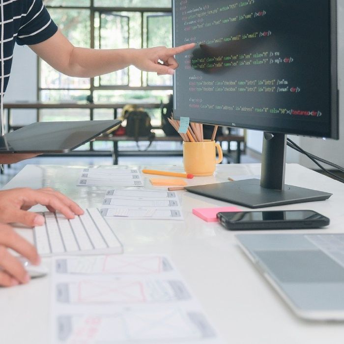 web developer coding a modern website on a desktop